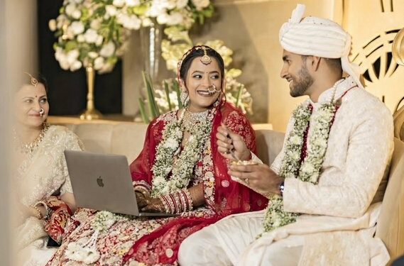 Bride Works on Laptop at Wedding