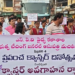 Students and officials holding banners during Krishna district cancer awareness rally